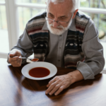 Older man eating soup