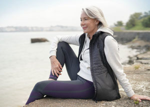 Image - Confident woman relaxing at a river shore