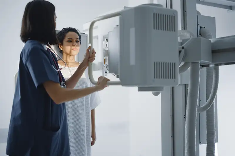 Doctor treating her patient in a scanning machine