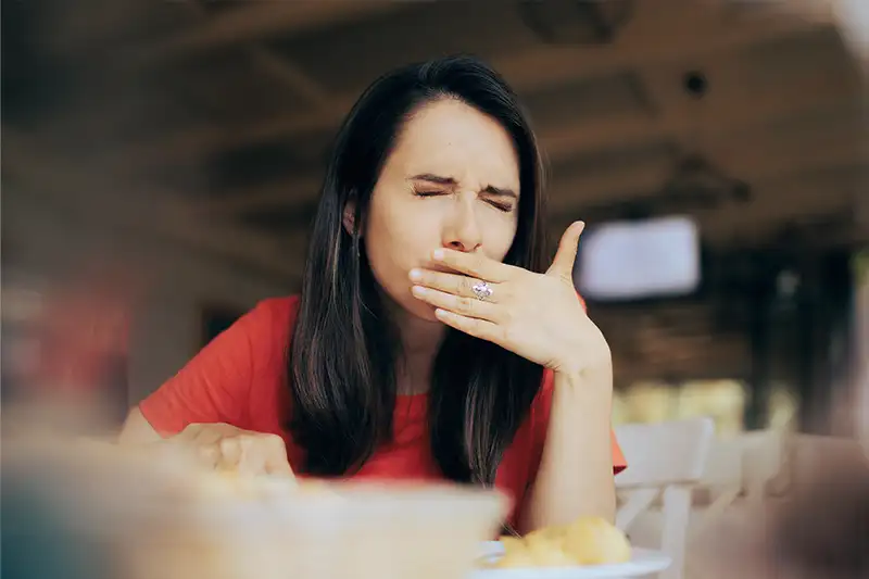 A woman experiencing issues while eating