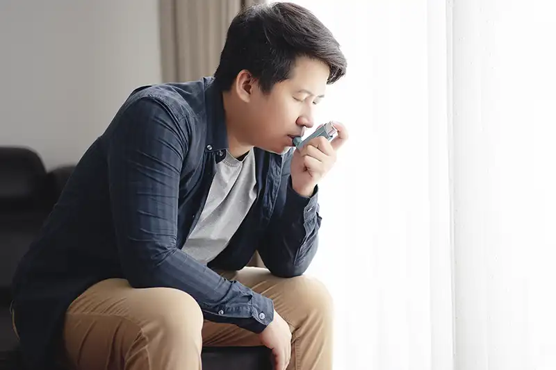 A person consuming medicine through a pump