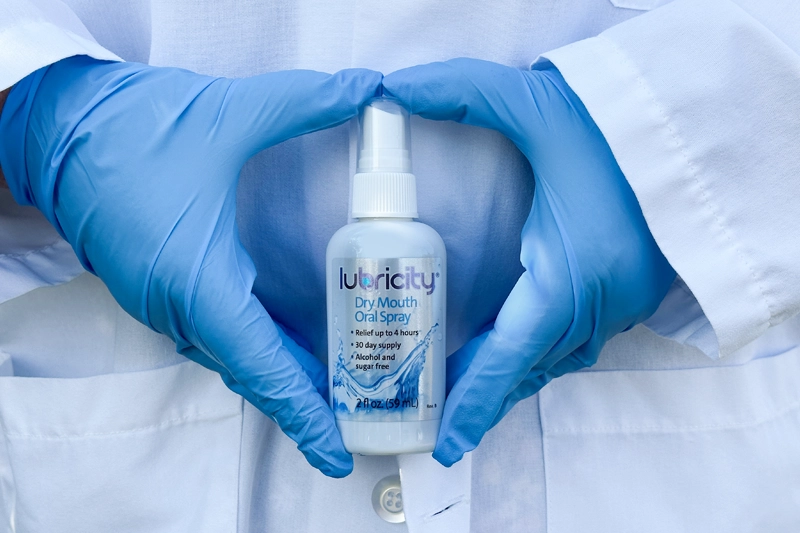 A person holding lubricity sample in a 2 fl oz bottle