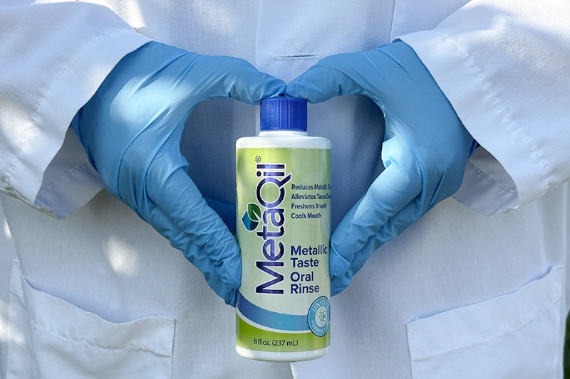 A person holding a Metaqil bottle (8 fl oz)