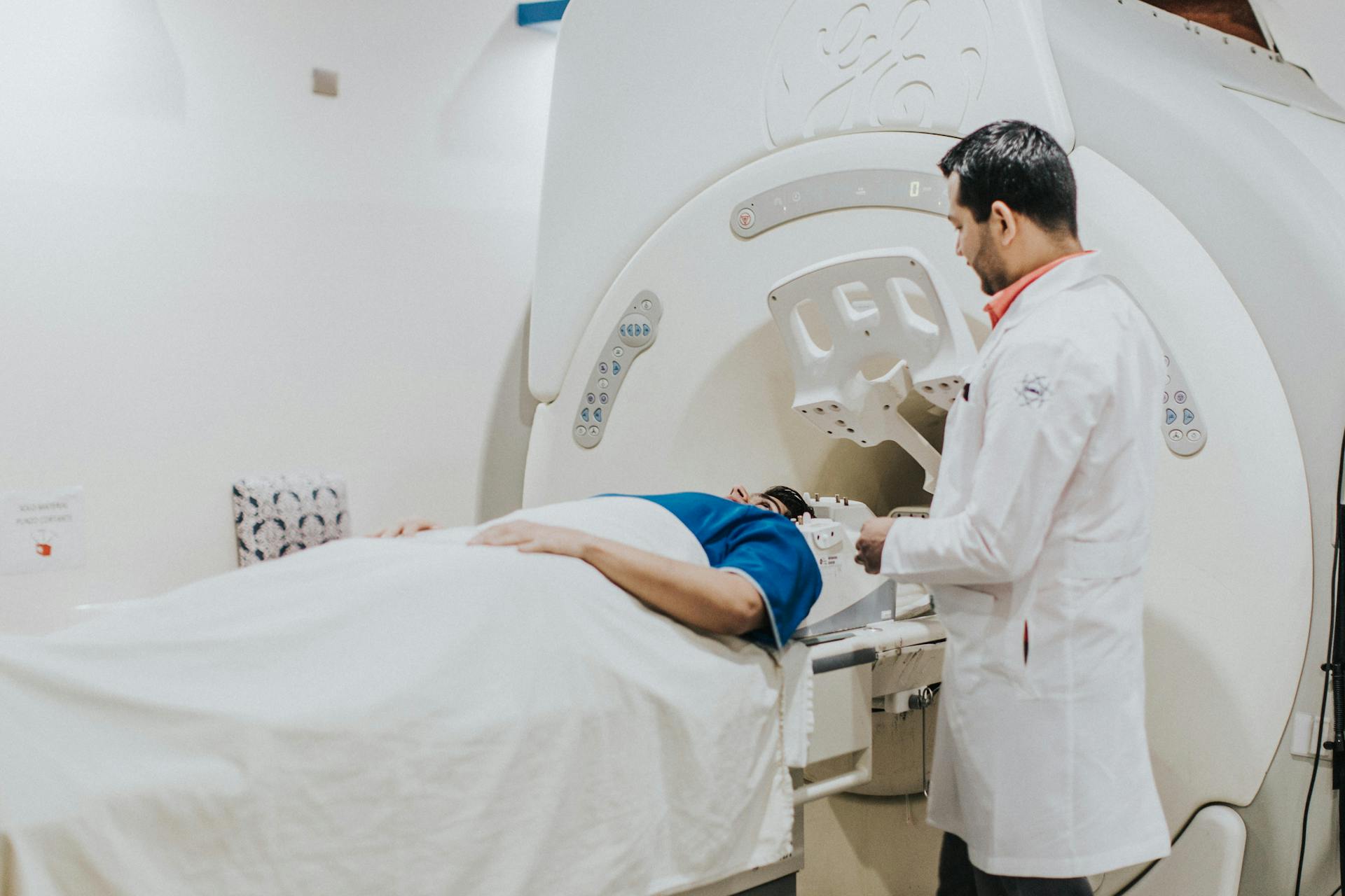 A doctor running an MRI test on his patient to uncover the root cause of the patient’s dysgeusia.