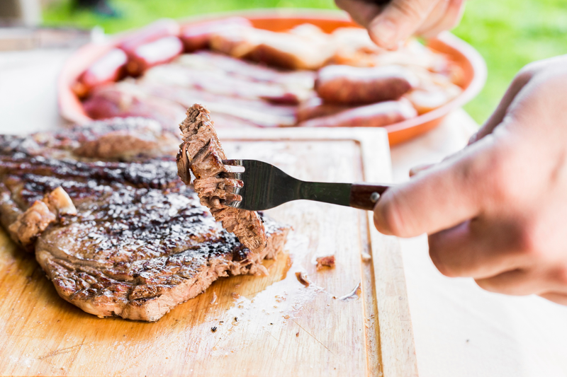 A person deciding whether or not to make dietary adjustments and not eat the steak in front of them due to the metallic taste Side effects of Paxlovid.