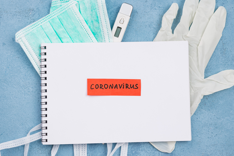 An image showing a pad of paper with the word “Coronavirus” on it to promote a better understanding of the Side effects of Paxlovid.