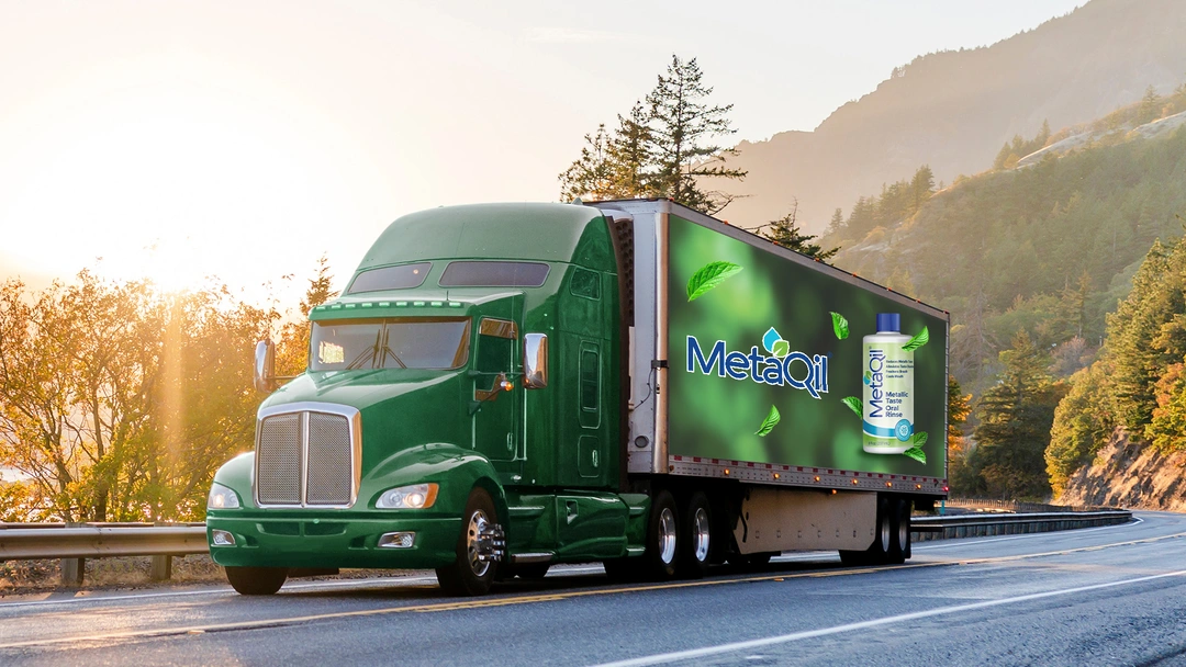 A truck with photo of Metaqil poster on it