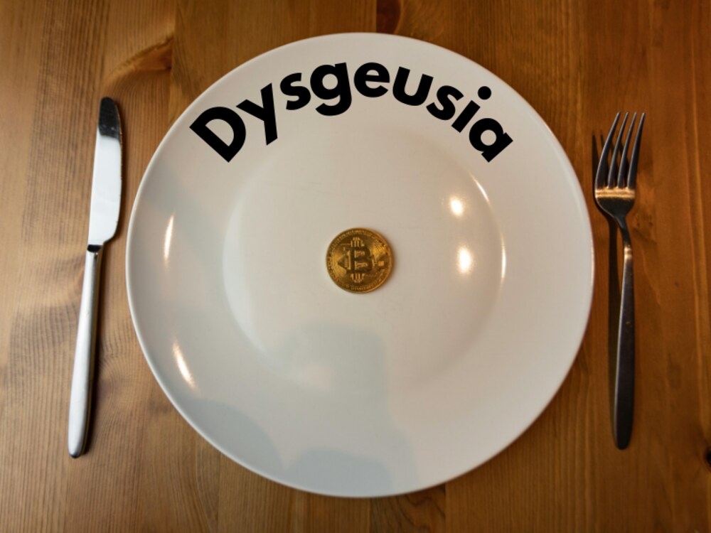 an image of a dinner plate with a coin on it and text “Dysgeusia” which is another term for metallic taste.