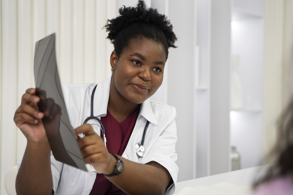 A doctor going over some early detection scans and discussing the possibility of metallic taste and cancer with her patient.