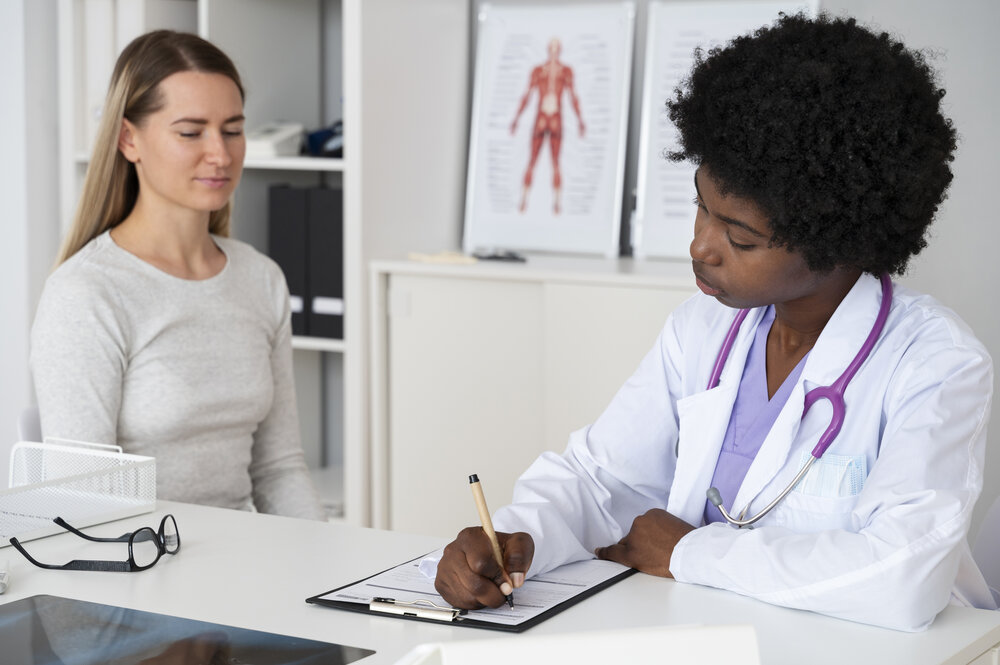 A doctor doing a clinical evaluation on her patient who has metallic taste and cancer.