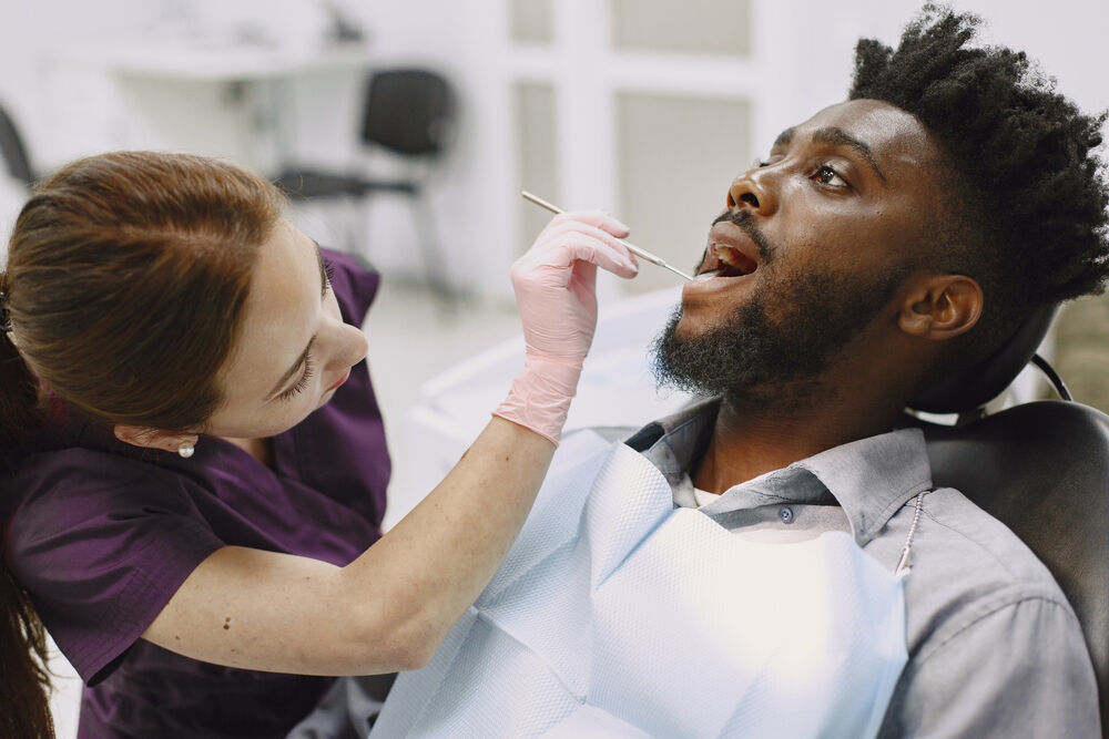 A man visiting the dentist because there’s been a metallic sensation impacting his taste buds.